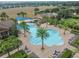 Stunning aerial view of a large community pool with ample seating and lush tropical landscaping at 252 Bayou Bend Rd, Groveland, FL 34736