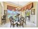 Dining room with water view, complemented by stylish furnishings and ample natural light at 252 Bayou Bend Rd, Groveland, FL 34736