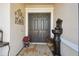 Stylish double doors flanked by decorative accents and potted plants creating an inviting entrance at 252 Bayou Bend Rd, Groveland, FL 34736