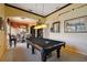 Game room with pool table, adjacent to the dining area and kitchen at 252 Bayou Bend Rd, Groveland, FL 34736