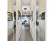 Hallway showing mirrored closet doors and leading into a room with beautiful natural light at 252 Bayou Bend Rd, Groveland, FL 34736