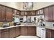 Spacious kitchen featuring granite countertops, wood cabinetry, and stainless steel appliances at 252 Bayou Bend Rd, Groveland, FL 34736