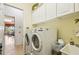 Laundry room includes a washer, dryer, sink, and storage, making chores a breeze at 252 Bayou Bend Rd, Groveland, FL 34736