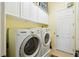 Bright laundry room with ample storage in the overhead cabinets and modern washer and dryer at 252 Bayou Bend Rd, Groveland, FL 34736