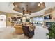 Large living room featuring a fireplace, tray ceiling, and bar area at 252 Bayou Bend Rd, Groveland, FL 34736