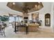 Open living room featuring a fireplace, tray ceiling, and views of the screened patio at 252 Bayou Bend Rd, Groveland, FL 34736