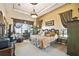 Luxurious main bedroom featuring tray ceiling, plush bedding, elegant furnishings, and serene ambiance at 252 Bayou Bend Rd, Groveland, FL 34736