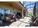 Relaxing screened patio with outdoor seating, perfect for enjoying the beautiful landscaped surroundings at 252 Bayou Bend Rd, Groveland, FL 34736