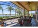 Relaxing screened patio with brick flooring overlooks lush landscaping and tranquil water views at 252 Bayou Bend Rd, Groveland, FL 34736