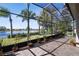 Open and airy screened patio with lake views and plenty of room for outdoor seating at 252 Bayou Bend Rd, Groveland, FL 34736