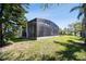 View of the large screened enclosure and landscaped yard at 252 Bayou Bend Rd, Groveland, FL 34736