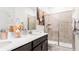 Bright bathroom featuring double sinks, a white countertop, and a tiled shower with sliding glass doors at 5038 Barnet Dr, Davenport, FL 33837