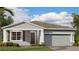 Charming single-story home featuring a well-manicured lawn, neutral paint, and an attached two-car garage at 5038 Barnet Dr, Davenport, FL 33837