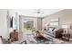 Inviting living room with a sliding glass door to the backyard, neutral tones, and a contemporary ceiling fan at 5038 Barnet Dr, Davenport, FL 33837