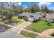 Aerial view of a single-Gathering home with a well-manicured lawn and mature trees at 282 Lake Griffin Cir, Casselberry, FL 32707