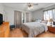 Cozy bedroom featuring hardwood floors, a ceiling fan, and neutral colors at 282 Lake Griffin Cir, Casselberry, FL 32707