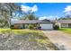 Single-story home features brick accents, mature trees and an attached two car garage at 282 Lake Griffin Cir, Casselberry, FL 32707