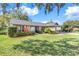 Well-manicured lawn and diverse landscaping create a welcoming curb appeal at 282 Lake Griffin Cir, Casselberry, FL 32707