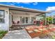 Outdoor patio with brick pavers, red chairs, and a bar area with a tiki torch at 282 Lake Griffin Cir, Casselberry, FL 32707