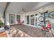 Covered brick patio with chairs and ceiling fan plus bicycles on the wall at 282 Lake Griffin Cir, Casselberry, FL 32707