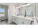This bathroom boasts a double sink vanity with white cabinets and matte black hardware at 3083 Voyager Ave, St Cloud, FL 34771