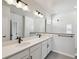 Modern bathroom with double sink vanity, matte black hardware, and glass enclosed shower at 3083 Voyager Ave, St Cloud, FL 34771