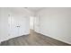 This bedroom features gray wood-look floors, closet, and white trim at 3083 Voyager Ave, St Cloud, FL 34771