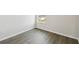This bedroom features gray wood-look floors, base trim, and a window at 3083 Voyager Ave, St Cloud, FL 34771