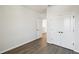 This bedroom features gray wood-look floors, closet, and white trim at 3083 Voyager Ave, St Cloud, FL 34771
