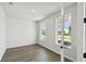 A bright and spacious room featuring stylish flooring, and ample natural light streaming through two large windows at 3083 Voyager Ave, St Cloud, FL 34771