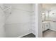 Walk-in closet with white wire shelving and access to the bathroom featuring a glass shower at 3083 Voyager Ave, St Cloud, FL 34771