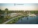 Scenic community view featuring a lake, walking path, lush landscaping, and community amenities at 3083 Voyager Ave, St Cloud, FL 34771