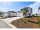 Charming two-story home features a white garage door, blue accents, and manicured landscaping at 3083 Voyager Ave, St Cloud, FL 34771