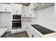 Modern kitchen boasts stainless steel appliances, white cabinets, and subway tile backsplash at 3083 Voyager Ave, St Cloud, FL 34771