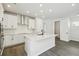 Bright kitchen features white cabinets, stainless steel appliances, and a center island with a breakfast bar at 3083 Voyager Ave, St Cloud, FL 34771