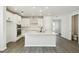 Bright kitchen featuring white cabinets, stainless appliances, quartz counters, subway tile and wood-look flooring at 3083 Voyager Ave, St Cloud, FL 34771