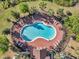 Aerial view of a zero entry community pool with ample seating, surrounded by lush greenery at 4706 Rockvale Dr, Kissimmee, FL 34758