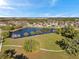 Aerial view of a tranquil lake, neighborhood, and a green space perfect for recreation and relaxation at 4706 Rockvale Dr, Kissimmee, FL 34758