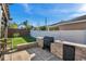 Outdoor kitchen with grill, sink, and counter space on the back patio at 4706 Rockvale Dr, Kissimmee, FL 34758