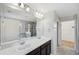 Bright bathroom with double sinks, large mirror, walk-in shower, and separate tub at 4706 Rockvale Dr, Kissimmee, FL 34758