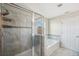 Bathroom showcasing a glass-enclosed shower and a separate soaking tub at 4706 Rockvale Dr, Kissimmee, FL 34758