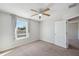 Bedroom with neutral walls and carpets, featuring a window and closet at 4706 Rockvale Dr, Kissimmee, FL 34758