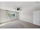Bright bedroom featuring a ceiling fan, a window and neutral carpeting at 4706 Rockvale Dr, Kissimmee, FL 34758