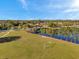 Stunning aerial view of the community park with lake, mature trees and green space at 4706 Rockvale Dr, Kissimmee, FL 34758