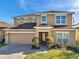 Charming two-story home with a brick driveway, manicured lawn, and well-maintained landscaping at 4706 Rockvale Dr, Kissimmee, FL 34758
