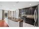 Modern kitchen featuring stainless steel appliances, granite countertops, and a stylish backsplash at 4706 Rockvale Dr, Kissimmee, FL 34758