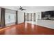 Open-concept living area with hardwood floors, natural light, ceiling fan, and a seamless transition to the kitchen at 4706 Rockvale Dr, Kissimmee, FL 34758