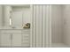 Clean bathroom featuring a vanity with storage and a tiled shower with a curtain at 5039 Barnet Dr, Davenport, FL 33837
