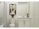 Modern bathroom with neutral tones, framed art, and a shower with decorative curtains at 5039 Barnet Dr, Davenport, FL 33837