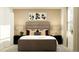 Comfortable bedroom featuring a queen bed, dark side tables with lamps and neutral wall decor at 5039 Barnet Dr, Davenport, FL 33837